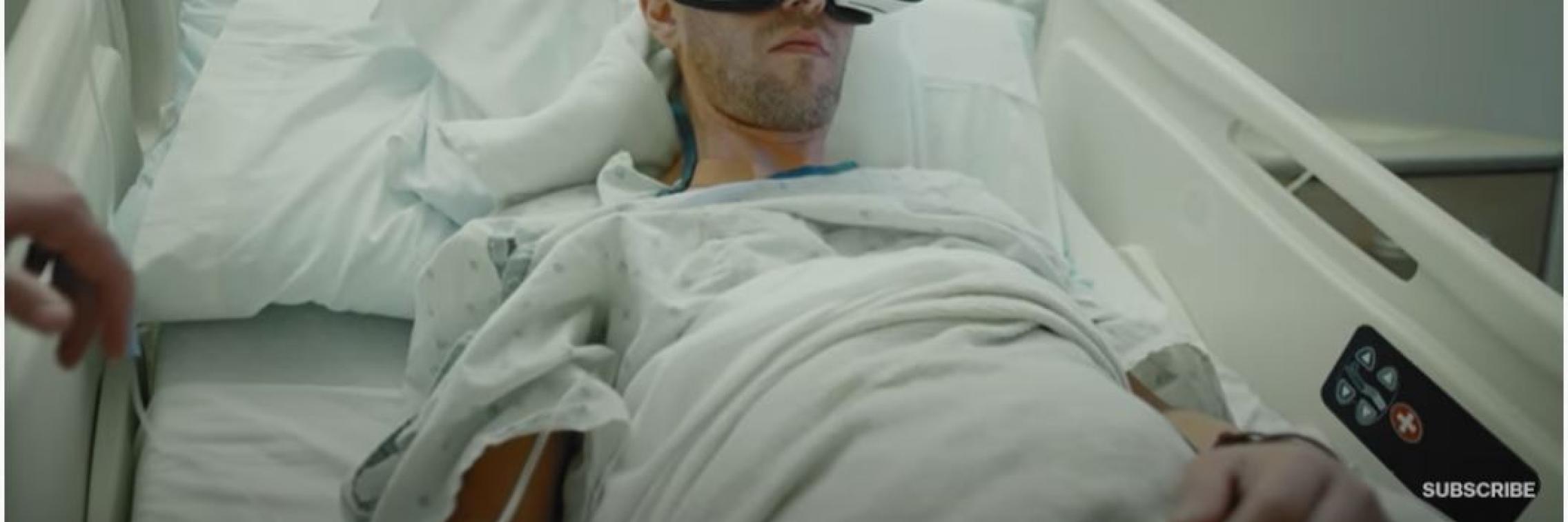 photo of patient with VR headset on in hospital bed