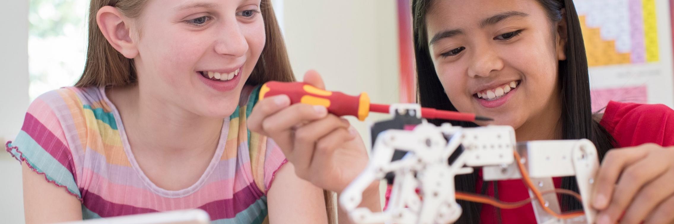 istock photo girls fixing a robot