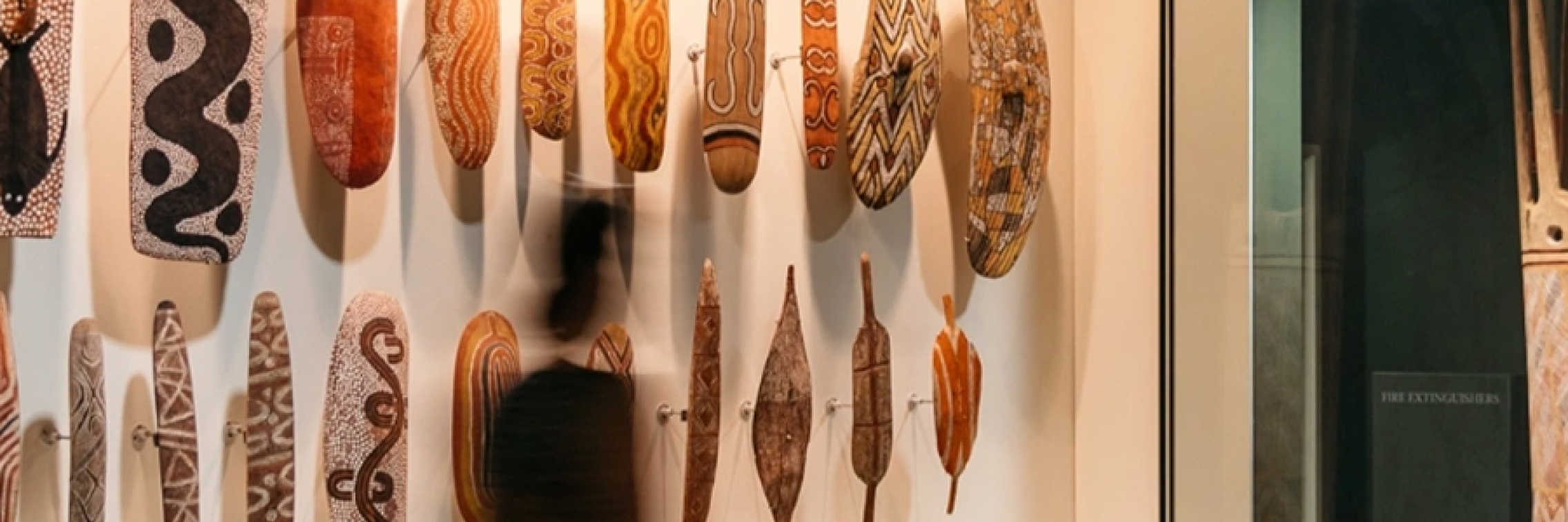adult and child walking in museum