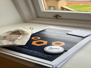 booklet and tape measure on window sill