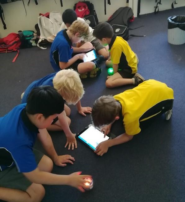 students working together with iPads and spheros