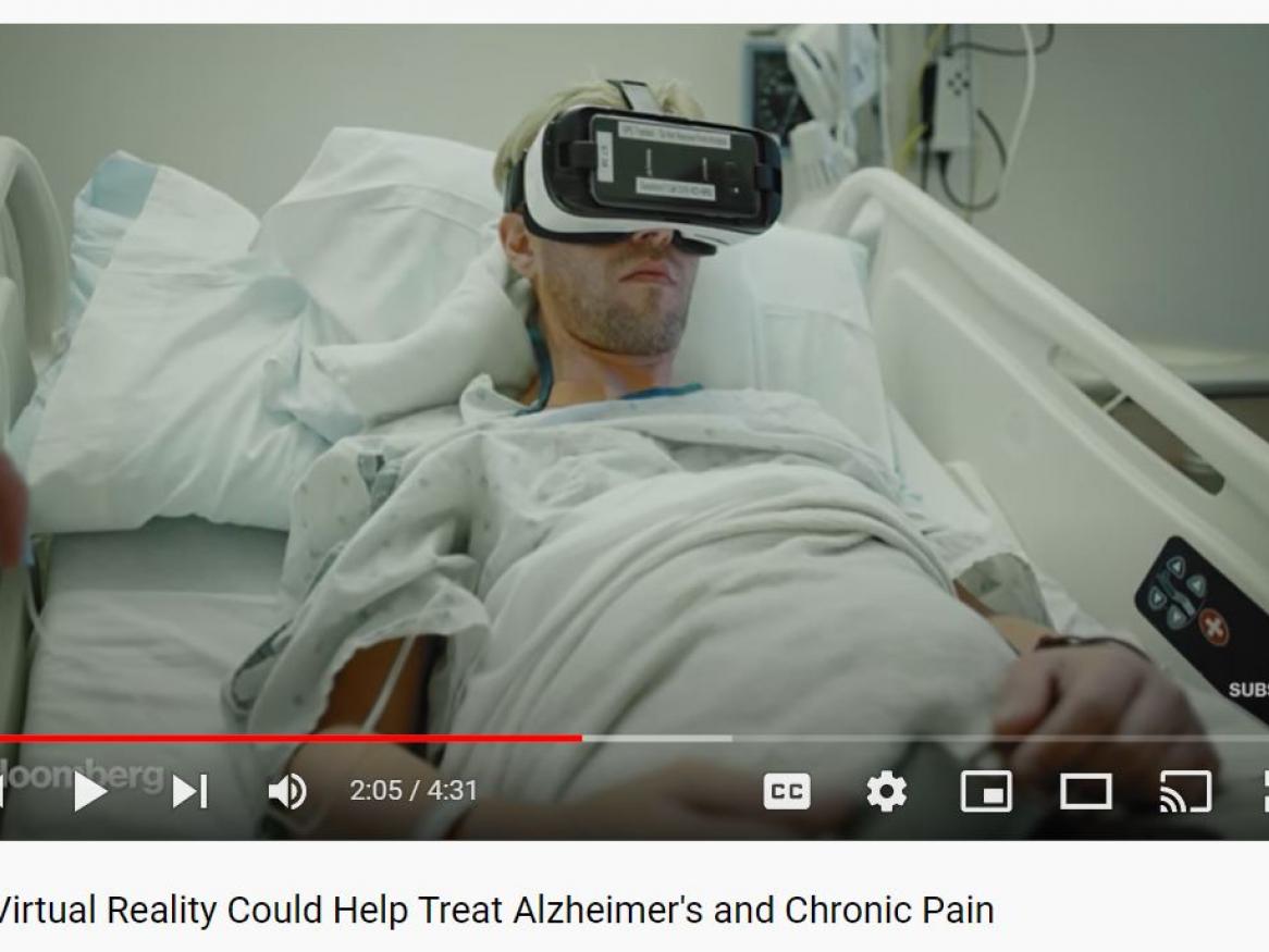 photo of patient with VR headset on in hospital bed