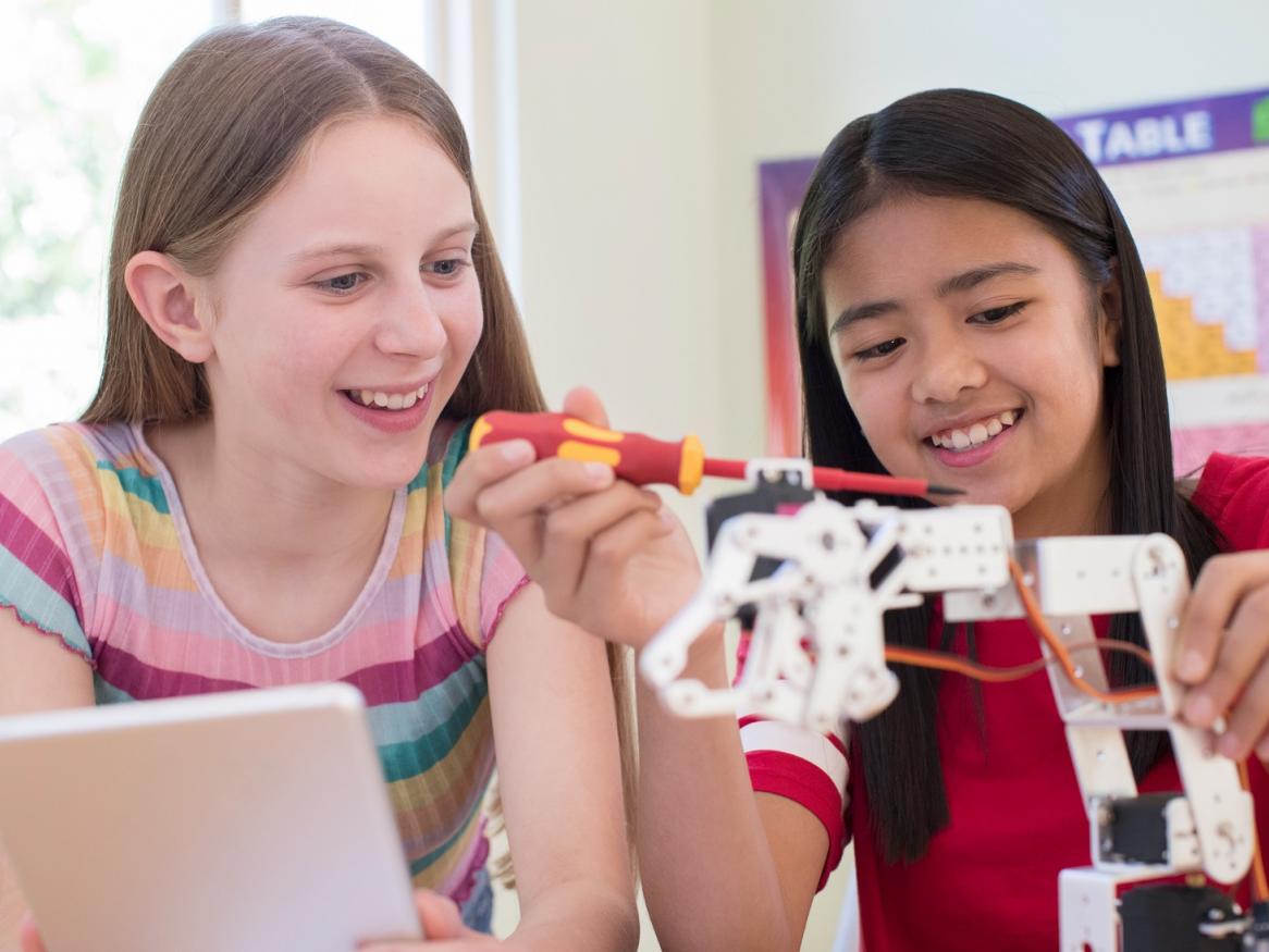 istock photo girls fixing a robot