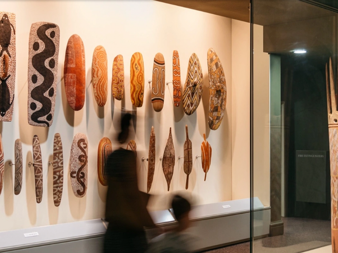 adult and child walking in museum